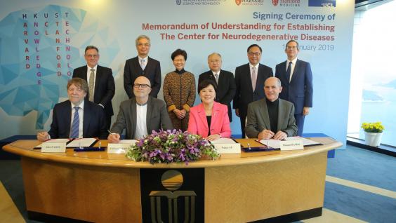 The Hon Mrs. Carrie LAM (back third left), Chief Executive of HKSAR; Mr. Andrew LIAO (back third right), HKUST Council Chairman; Prof. Wei SHYY (back second left), HKUST President; Mr. Nicholas W YANG (back second right), Secretary for Innovation and Technology; Mr. Andrew HEYN (back first left), British Consul General in Hong Kong and Mr. Thomas HODGES (back first right), Acting U.S. Consul General in Hong Kong witness the MoU signing between Prof. Nancy IP (front second right), HKUST Vice-President for Re
