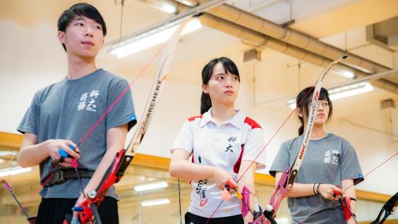 Edith practices archery with teammates regularly.