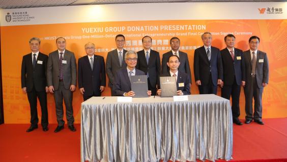 HKUST President Prof. Wei SHYY (front left) and Yuexiu General Manager Mr. ZHU Chunxiu (front right) sign the HK$100 million donation agreement under the witness of officiating guests including Mr. Kevin YEUNG Yun-Hung, Secretary for Education, HKSAR (back row, fourth left); Mr. YANG Jian, Deputy Director of the Liaison Office at the Central People's Government in the HKSAR (back row, middle); Mr. YANG Yirui, Deputy Commissioner of the Ministry of Foreign Affairs of the People's Republic of China in th