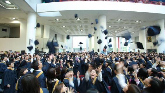 毕 业 生 将 礼 帽 抛 至 半 空 ， 以 示 庆 祝	