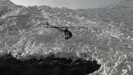  The helicopter flying over a glacier