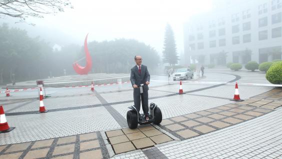  President Chan has a try on a light electric vehicle.