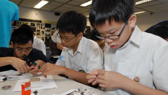 Students work with full concentration as they construct their own electronic dice.	