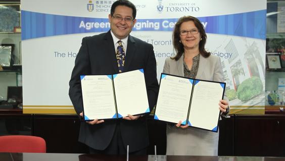  HKUST Dean of Engineering Prof Khaled Ben Letaief and U of T Dean of Faculty of Applied Science and Engineering Prof Cristina Amon sign the agreement at HKUST.